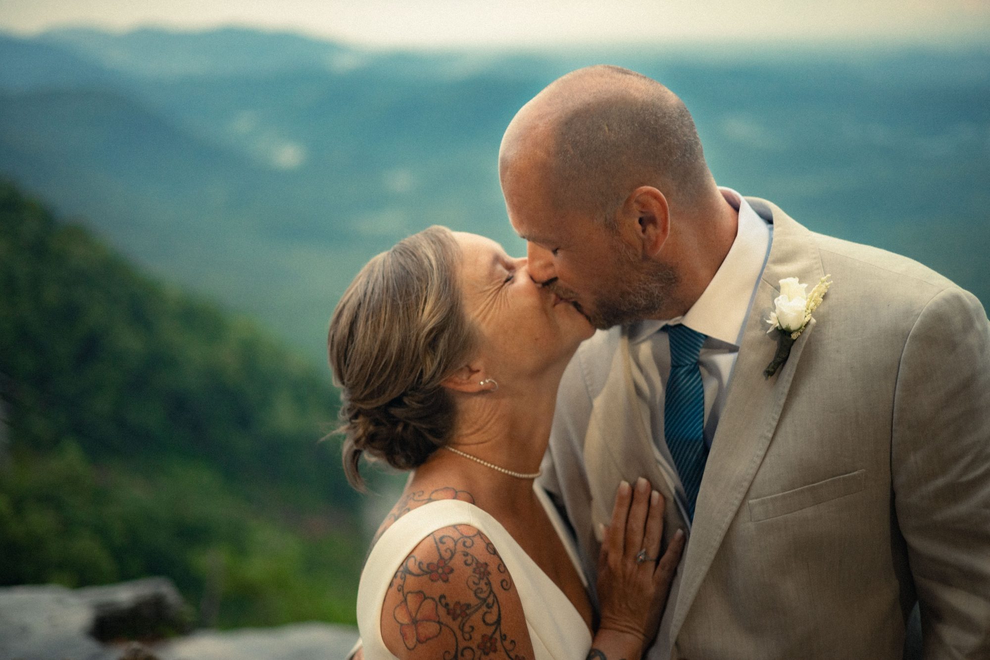 Wedding kiss on mountain overlook
