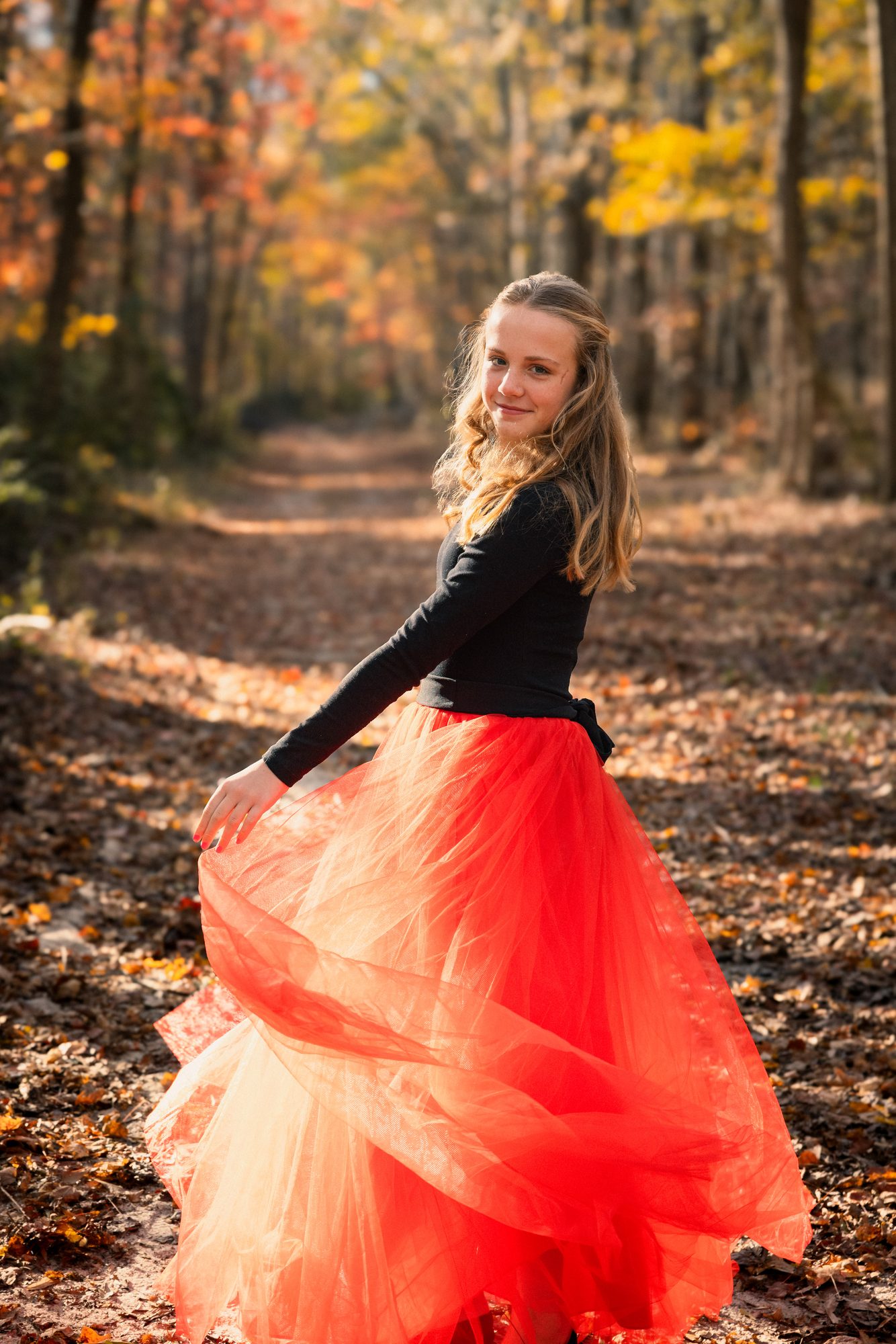 Girl in red tutu, autumn woods
